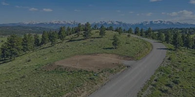 A beautiful, gently sloping build site on a piece of vacant land in Pagosa Springs, looking out toward the scenic San Juan Mountains.